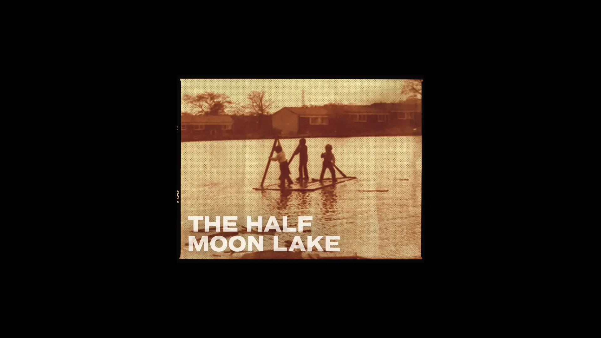 Vintage sepia photo of children on a raft at The Half Moon Lake, showcasing creative brand design and storytelling elements.