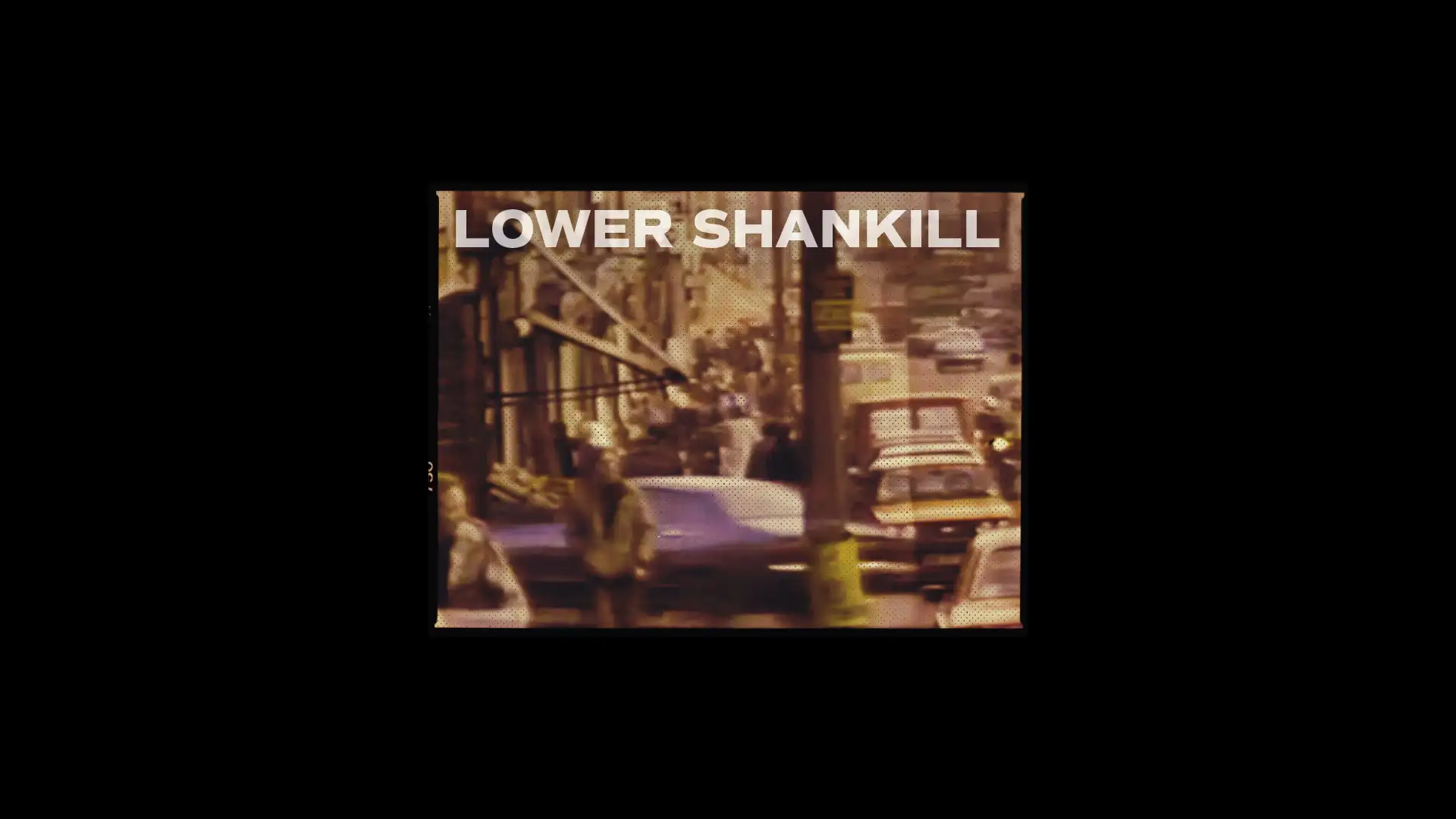 Vintage street scene of Lower Shankill featuring retro cars and pedestrians, showcasing creative brand design elements.
