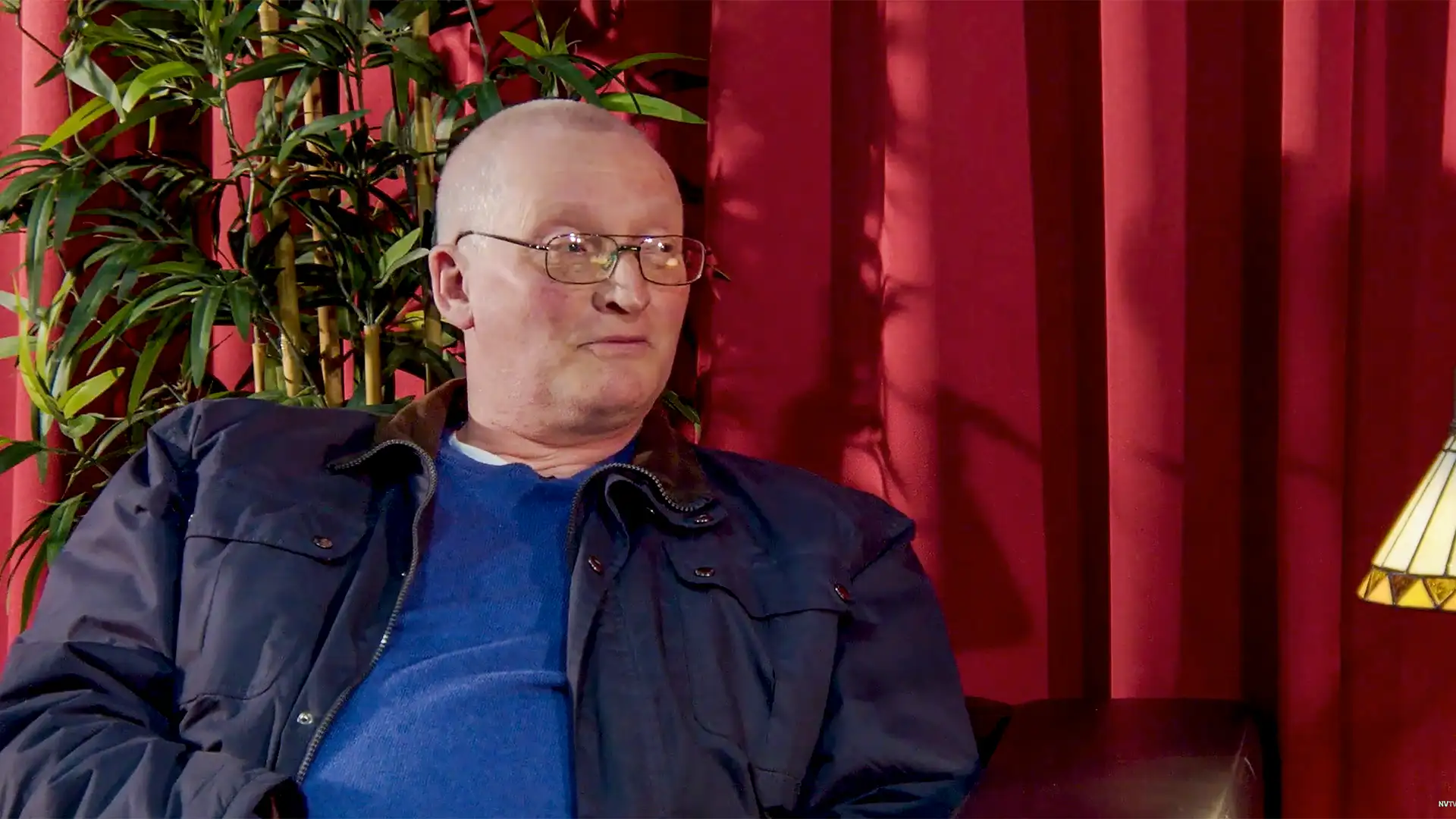 Ian Martin from Our Generation discusses brand development and strategy in a warm, professional setting with red curtains and greenery.