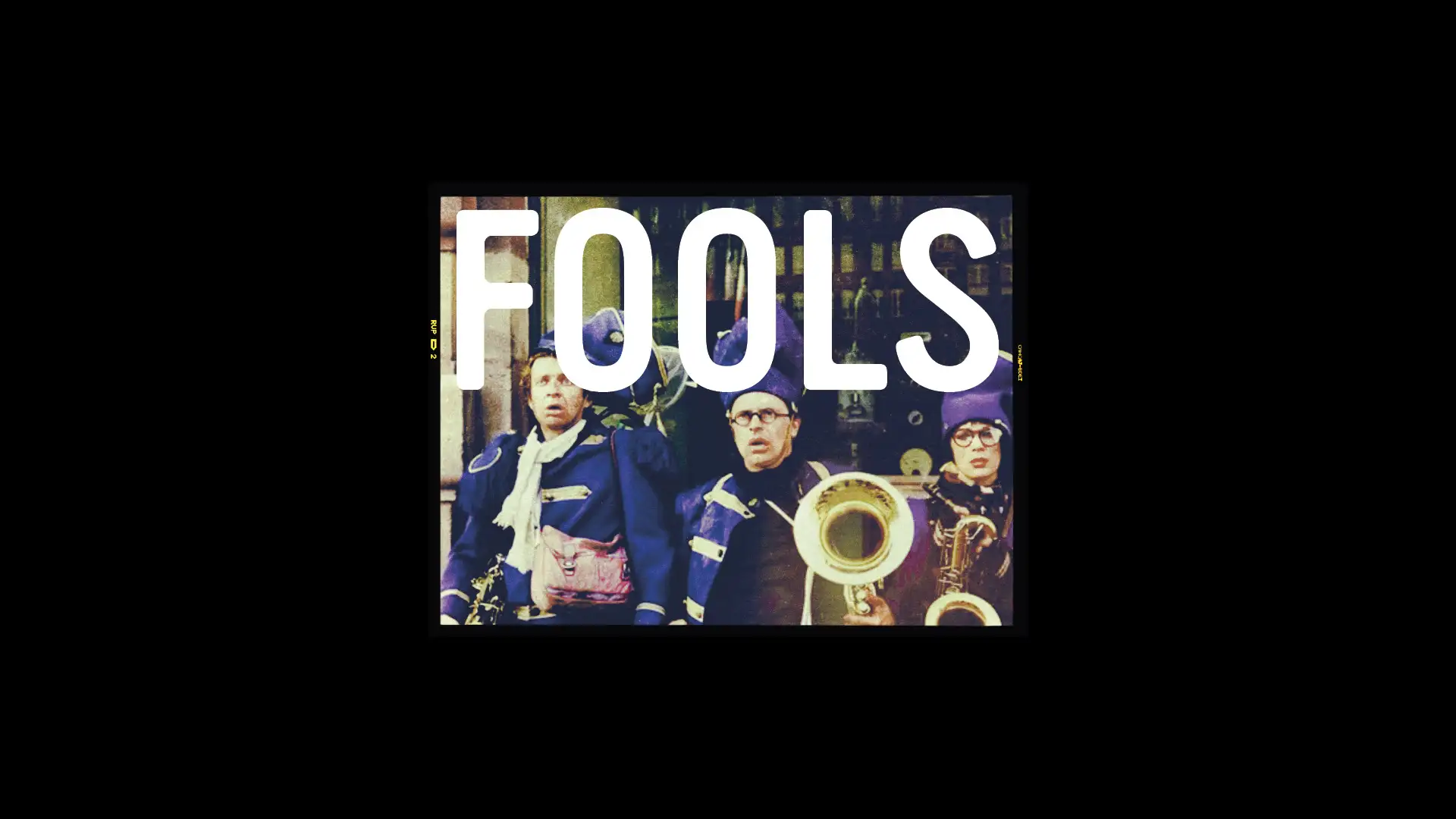 Album/poster cover featuring a vintage brass band in blue costumes with oversized white 'FOOLS' text across the image.